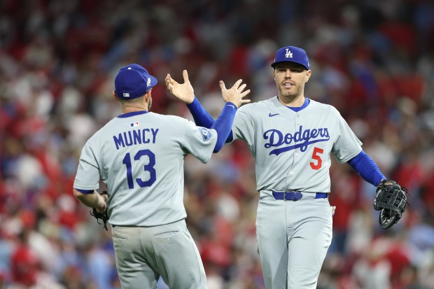 Dodgers first baseman Freddie Freeman, right, celebrates with third baseman...