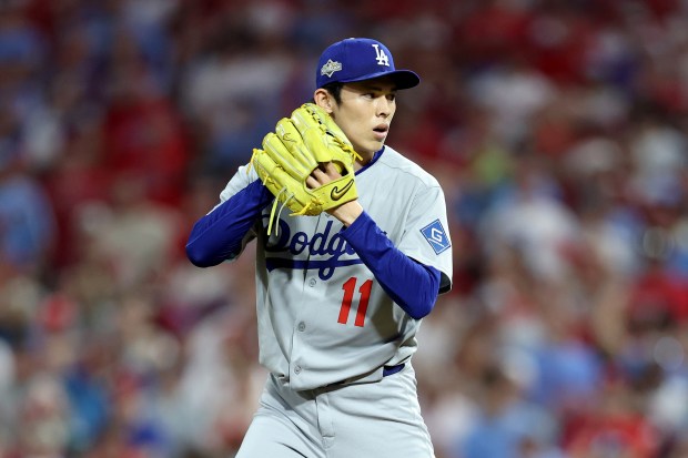 Dodgers relief pitcher Roki Sasaki pitches in the ninth inning...
