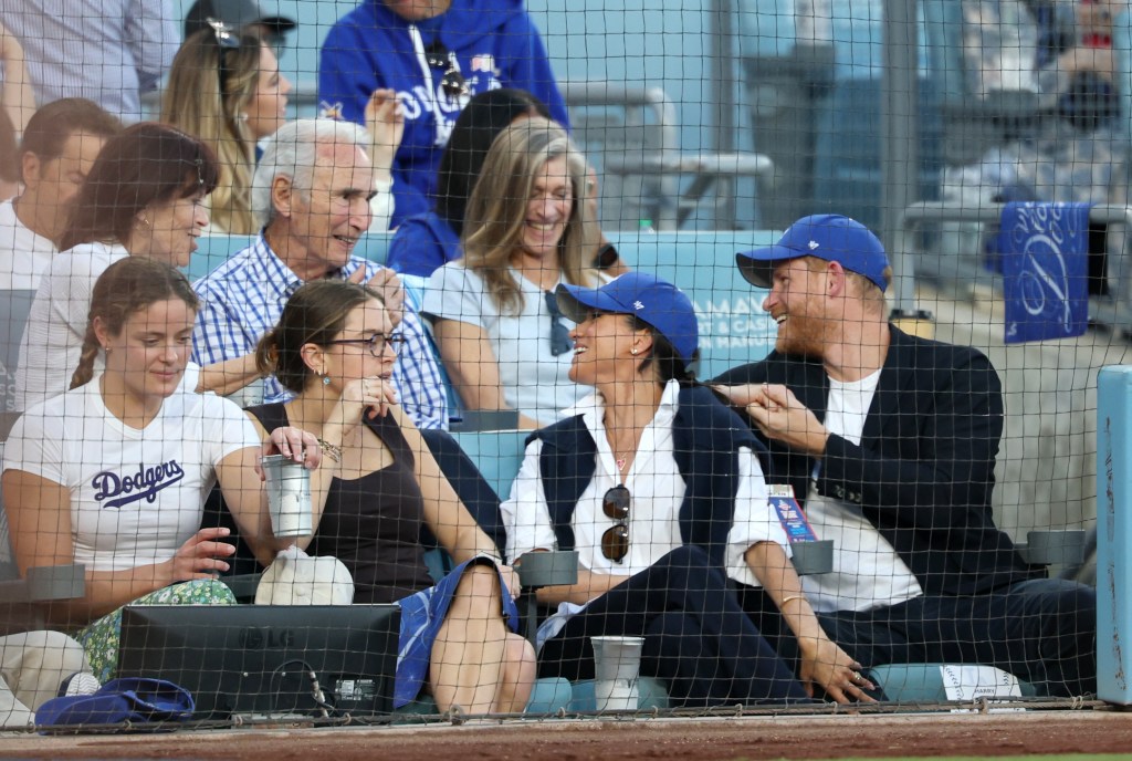 Prince Harry and Meghan Markle, the Duke and Duchess of Sussex, sit in front of Dodger legend Sandy Koufax as they watch Game four of the World Series between the Los Angeles Dodgers and the Toronto Blue Jays at Dodger Stadium on Tuesday, October 28, 2025 in Los Angeles, CA. 