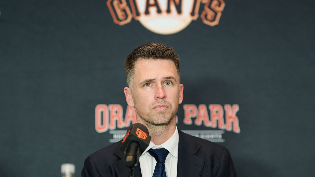 San Francisco Giants president of baseball operations Buster Posey listens during the introductory press conference for shortstop Willy Adames (not pictured) at Oracle Park.