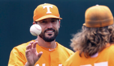 Tennessee head coach Tony Vitello, left, talks with pitcher Kirby Connell before an NCAA college ba...
