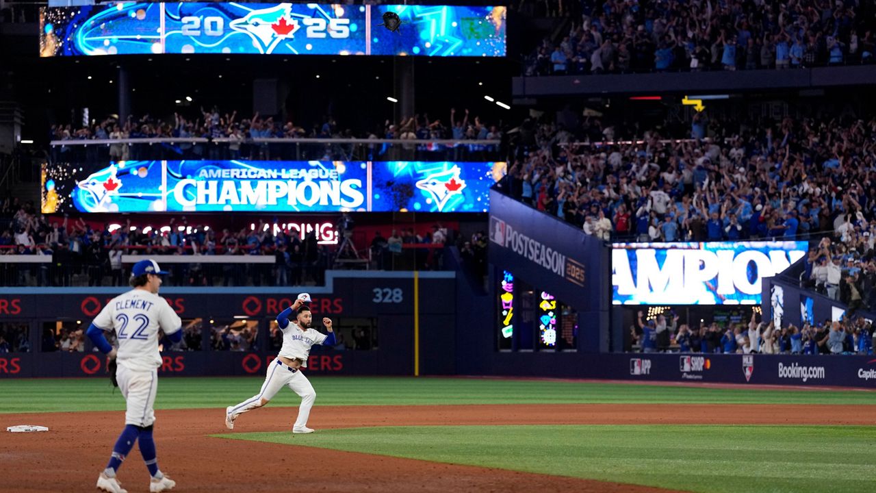 Ernie Clement (22) and Isiah Kiner-Falefa of the Toronto Blue Jays celebrate after their Game 7 ALCS victory against the Seattle Mariners on Monday in Toronto.