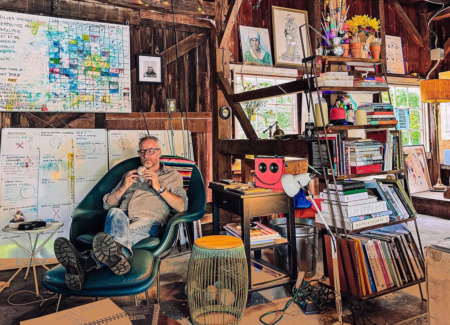 Matt Berninger sits in a chair in his Connecticut workshop