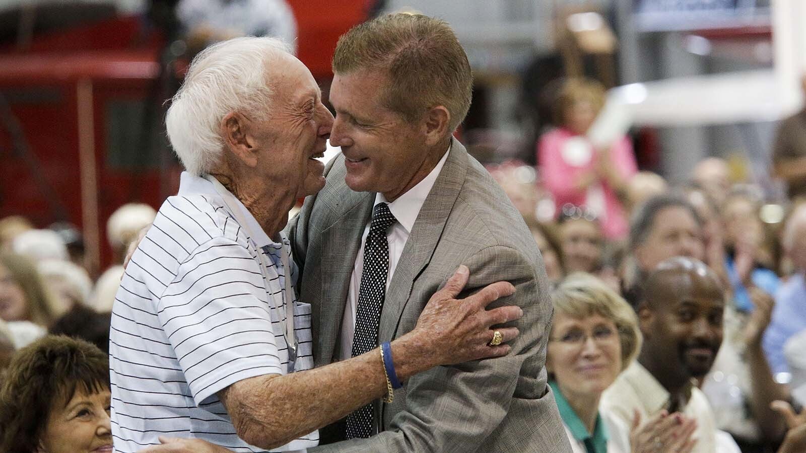 Capt. Al Haynes, left, and survivor Jerry Schemmel embrace before Schemmel gives remarks as former United Airlines Flight 232 crew members, first responders and others attend a reflection ceremony July 19, 2014, remembering those who died in the crash of United Airlines Flight 232 25 years later at the Mid-American Museum of Aviation and Transportation in Sioux City, Iowa.