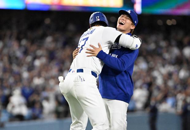 Shohei Ohtani #17 celebrates with teammate Yoshinobu Yamamoto #18 of...