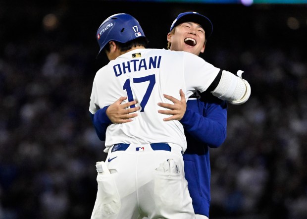 Shohei Ohtani #17 celebrates with teammate Yoshinobu Yamamoto #18 of...