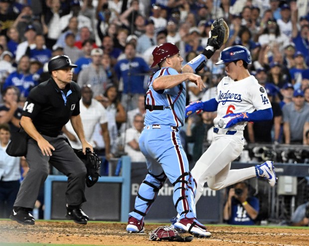 The Dodgers’ Hyeseong Kim, right, scores the winning run as...