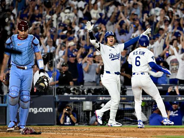 Shohei Ohtani, left, celebrates with teammate Hyeseong Kim #6 of...