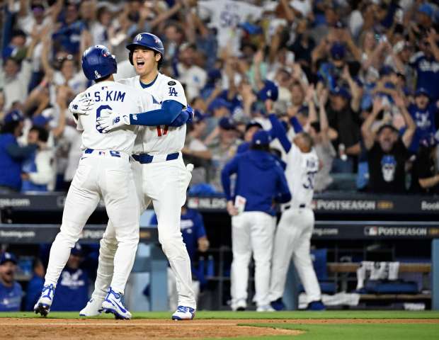 Shohei Ohtani, left, celebrates with teammate Hyeseong Kim #6 of...
