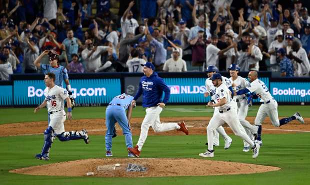 The Dodgers run past Philadelphia Phillies relief pitcher Orion Kerkering...