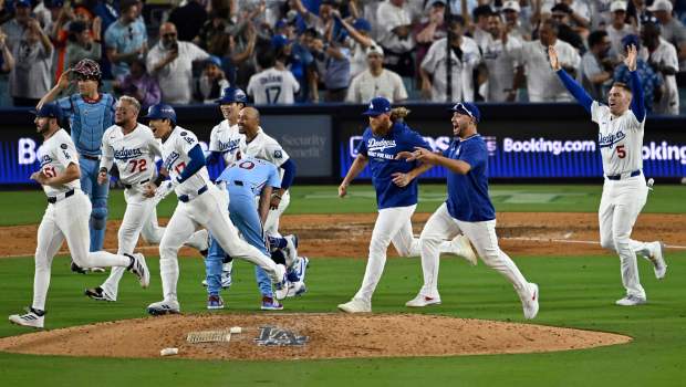 The Dodgers run past Philadelphia Phillies relief pitcher Orion Kerkering...