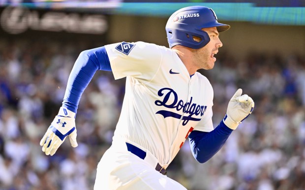 The Dodgers’ Freddie Freeman runs after hitting a single during...
