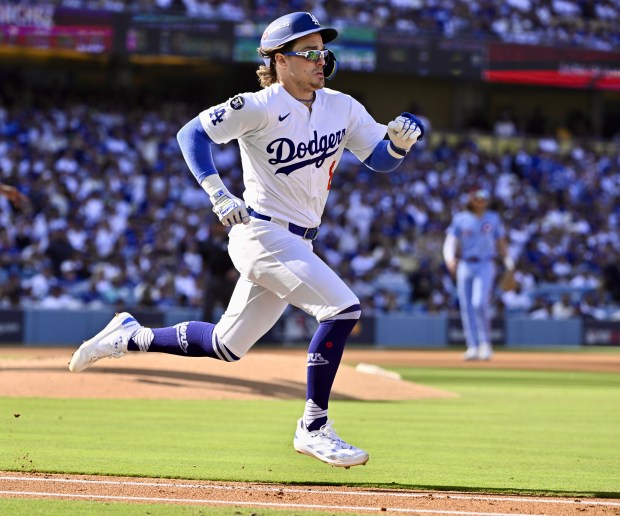 The Dodgers’ Kike Hernandez runs up the line and is...