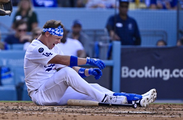 The Dodgers’ Alex Call reacts after being hit by a...