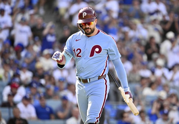 Philadelphia Phillies slugger Kyle Schwarber walks back to the dugout...