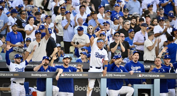 The Dodgers’ dugout reacts as teammate Teoscar Hernández (not pictured)...