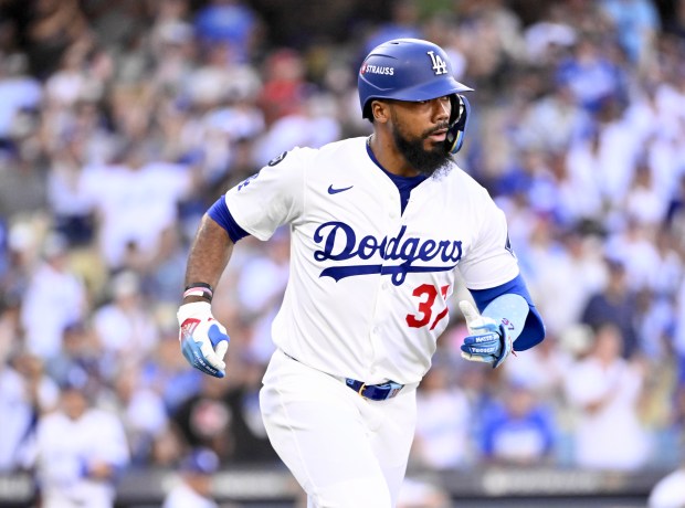 The Dodgers’ Teoscar Hernández runs after hitting a single during...