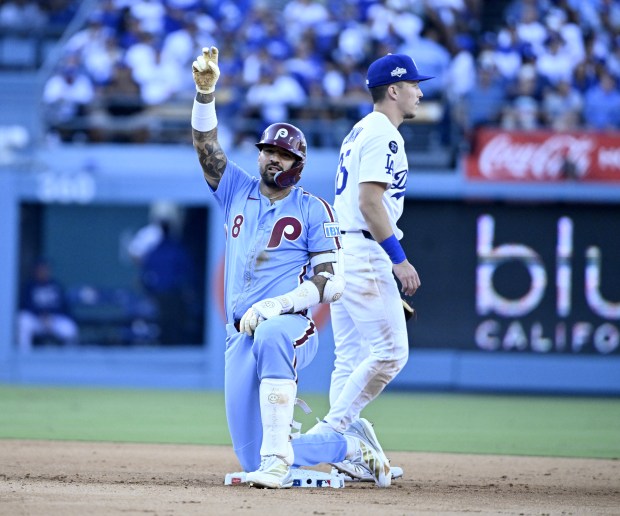 The Philadelphia Phillies’ Nick Castellanos gestures to his dugout after...