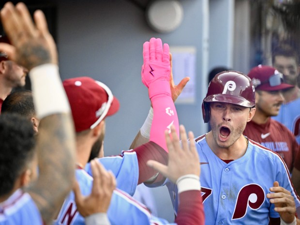 The Philadelphia Phillies’ Max Kepler, right, celebrates in the dugout...