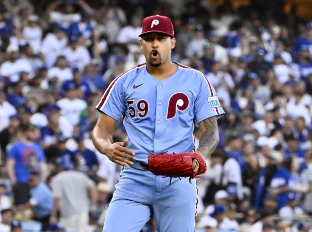Philadelphia Phillies relief pitcher Jhoan Duran reacts after striking out...