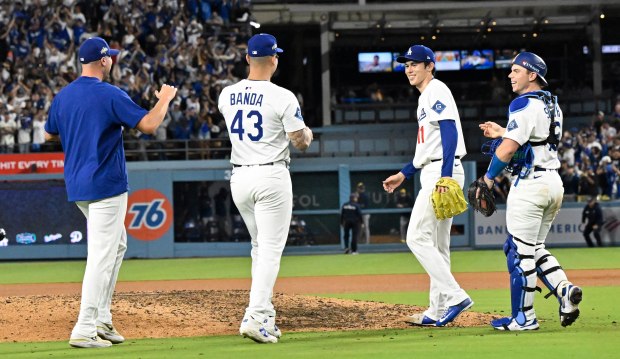 Cather Will Smith, right, along with relief pitcher Roki Sasaki...