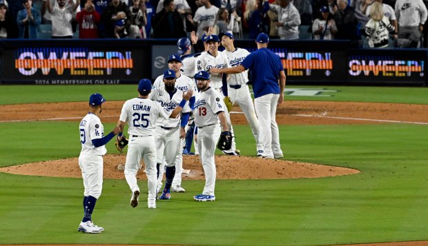 The Los Angeles Dodgers celebrate after defeating the Milwaukee Brewers...