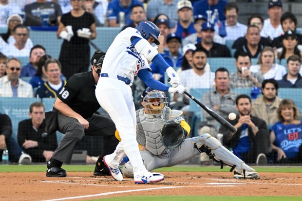 Dodgers star Shohei Ohtani connects for a solo home run...