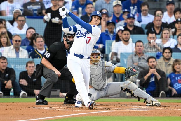 Dodgers star Shohei Ohtani watches the flight of his solo...