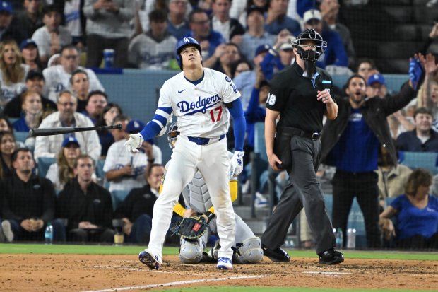 Dodgers star Shohei Ohtani watches the flight of his solo...
