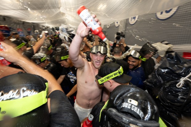 Dodgers celebrate their sweep of the NLCS with champagne after...