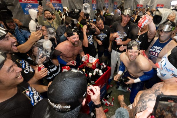 Dodgers celebrate their sweep of the NLCS with champagne after...