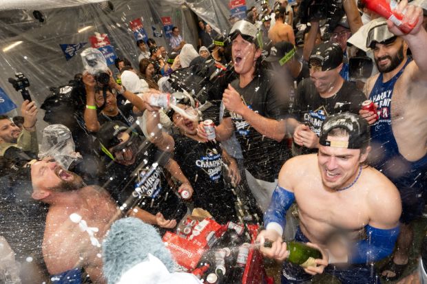 Dodgers celebrate their sweep of the NLCS with champagne after...