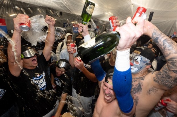 Dodgers celebrate their sweep of the NLCS with champagne after...