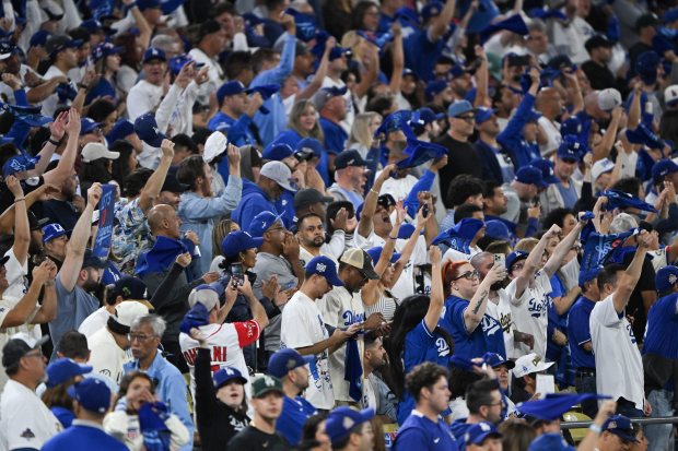 Dodger fans celebrate the sweep of the NLCS after defeating...