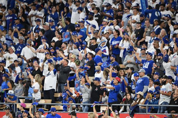 Dodger fans celebrate the sweep of the NLCS after defeating...