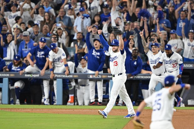 Dodgers cerebrate after the final out in game four of...
