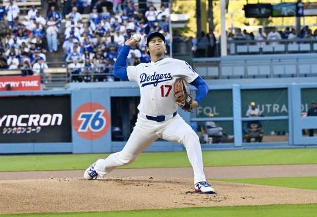 Dodgers starting pitcher Shohei Ohtani throws to the plate during...