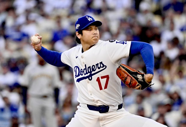 Dodgers starting pitcher Shohei Ohtani throws to the plate during...
