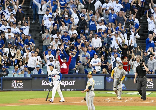 Dodgers star Shohei Ohtani watches the flight of his solo...