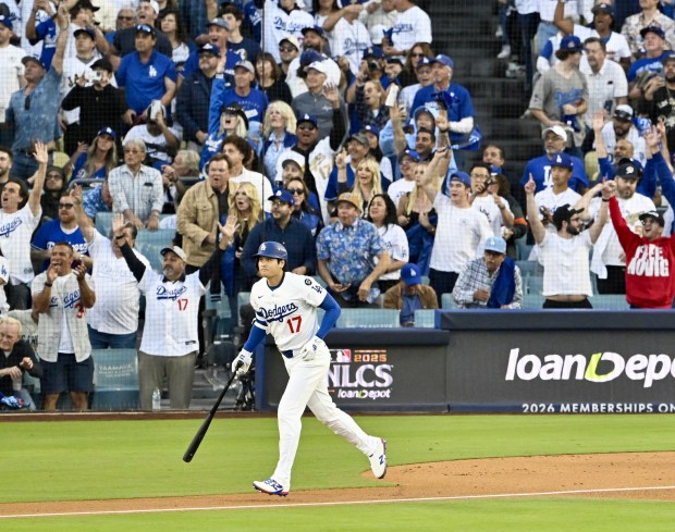 Dodgers star Shohei Ohtani watches the flight of his solo...