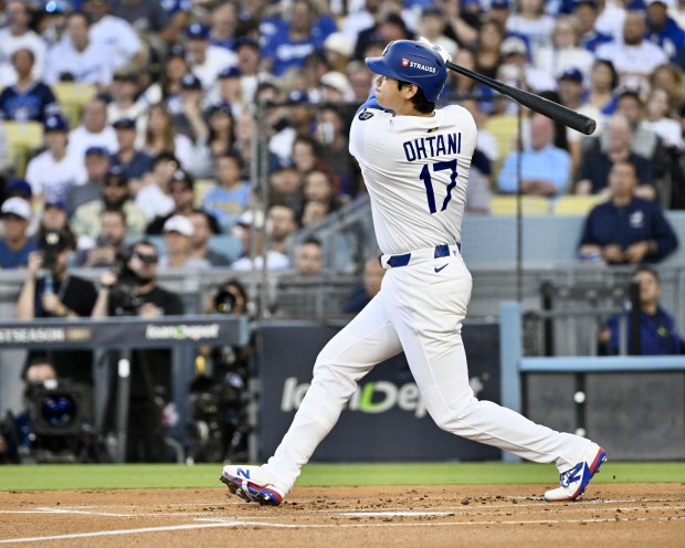 Dodgers star Shohei Ohtani watches the flight of his solo...