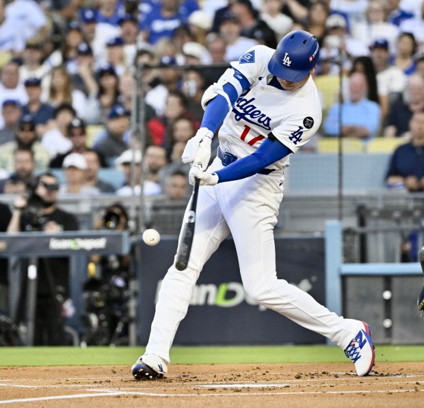 Dodgers star Shohei Ohtani hits a solo home run during...