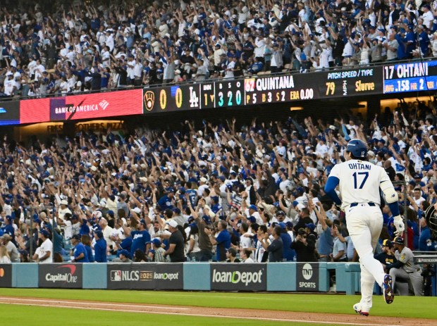 Dodgers star Shohei Ohtani begins to run the bases as...