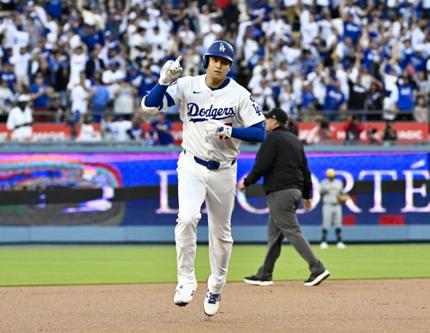 Dodgers star Shohei Ohtani gestures as he runs the bases...