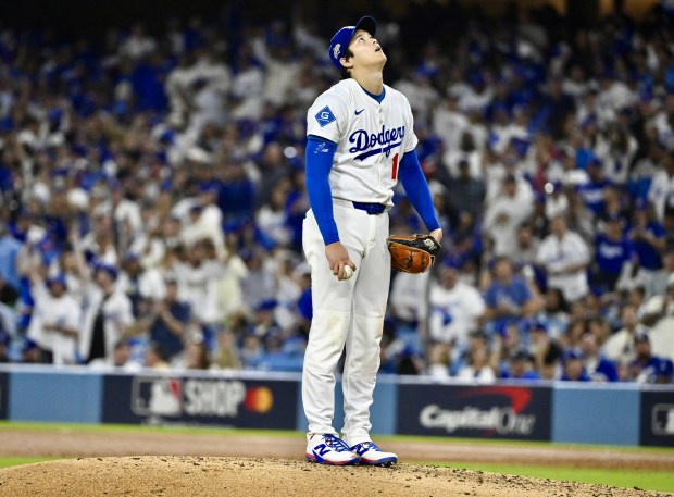 Dodgers starting pitcher Shohei Ohtani takes a moment on the...