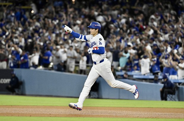 Dodgers star Shohei Ohtani celebrates as he runs the bases...