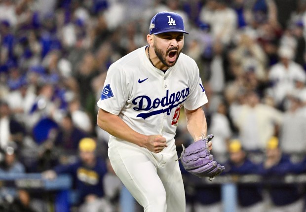 Dodgers relief pitcher Alex Vesia celebrates after inducing an inning-ending...