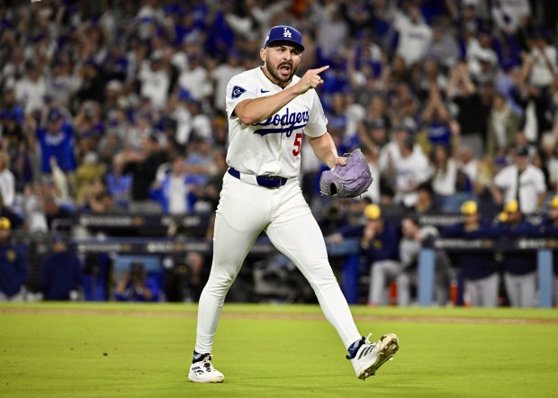 Dodgers relief pitcher Alex Vesia celebrates after inducing an inning-ending...
