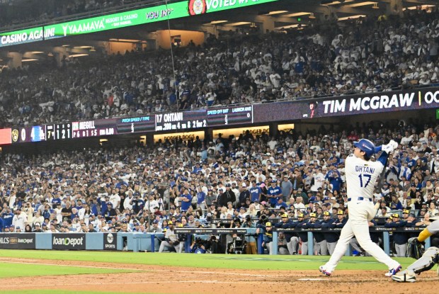 Dodgers star Shohei Ohtani watches the flight of his solo...