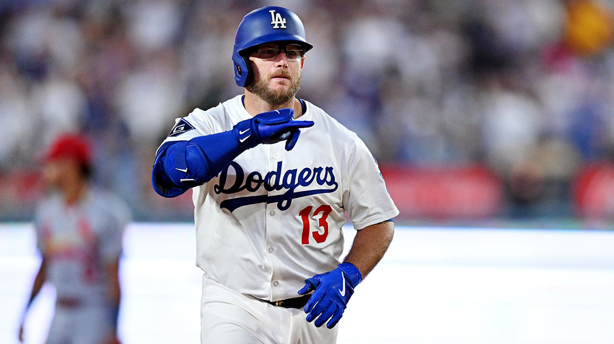 Los Angeles Dodgers third baseman Max Muncy (13) hits a two run home run during the third inning against the St. Louis Cardinals at Dodger Stadium.